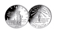 Silver coin featuring a full figure view of the Statue of Liberty in front of the main building of Ellis Island 